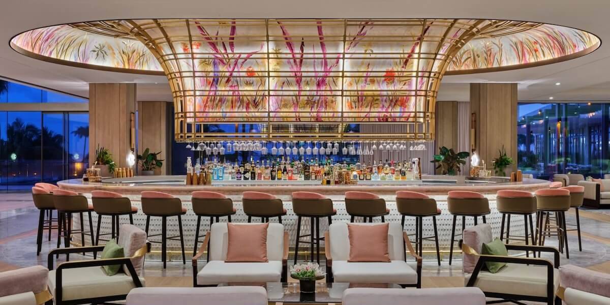 The St. Regis Bar at the St. Regis Longboat Key Resort, with its floral glass canopy over the bar